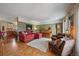 Cozy living room with a warm color palette, hardwood floors and a grand piano at 7356 S Miller Ct, Littleton, CO 80127