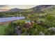 Picturesque aerial shot showcases a charming estate, set against a serene lake and lush greenery at 700 Utica Ave, Boulder, CO 80304