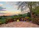 A stone backyard patio featuring a waterfall surrounded by lush greenery and colorful flowers at 700 Utica Ave, Boulder, CO 80304