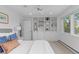 Bright bedroom with built-in bookshelves and a large window overlooking the outdoors at 700 Utica Ave, Boulder, CO 80304