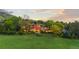 Elegant multi-story home boasting expansive windows, manicured landscaping, and a lush green lawn at 700 Utica Ave, Boulder, CO 80304