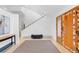 Bright foyer with modern staircase, beautiful wood floors, and custom front door at 700 Utica Ave, Boulder, CO 80304