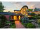 Charming home entrance with unique architectural details, lush landscaping, and warm, inviting lighting at 700 Utica Ave, Boulder, CO 80304