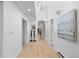 Bright hallway featuring hardwood floors, modern lighting, and stylish artwork at 700 Utica Ave, Boulder, CO 80304