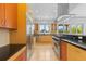 Bright kitchen with stainless appliances, light wood cabinetry, and large windows at 700 Utica Ave, Boulder, CO 80304