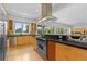 Well-lit kitchen with stainless steel appliances, custom cabinets, and a large center island at 700 Utica Ave, Boulder, CO 80304