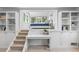 Cozy living room with built-in shelves and desk space, plus elevated bedroom at 700 Utica Ave, Boulder, CO 80304
