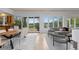 This open-concept living room features lots of light, a dining area, and access to a patio at 700 Utica Ave, Boulder, CO 80304