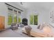Serene main bedroom with fireplace, sitting area, and a view of the trees at 700 Utica Ave, Boulder, CO 80304