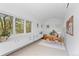 Bright office with a mid-century modern desk, large windows, and built-in storage at 700 Utica Ave, Boulder, CO 80304