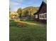 A view of the backyard with lush greenery, plants, and a scenic mountain backdrop at 245 Lower Glenway St, Palmer Lake, CO 80133