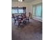 Dining room features a wood table with chairs, neutral colored carpet, and natural light from the window at 245 Lower Glenway St, Palmer Lake, CO 80133