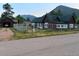 Street view of home and detached garage, with a well-maintained yard and fencing at 245 Lower Glenway St, Palmer Lake, CO 80133
