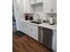 Bright kitchen features stainless steel appliances, double sinks, and ample white cabinetry at 245 Lower Glenway St, Palmer Lake, CO 80133