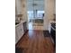 Spacious kitchen with stainless appliances and wood floors leading into a well-lit living area at 245 Lower Glenway St, Palmer Lake, CO 80133