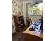 Bright office space with classic wooden desk, chair, and view to peaceful neighborhood at 245 Lower Glenway St, Palmer Lake, CO 80133