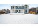 Backyard showcasing the home's blue siding, patio with pergola, and grassy yard at 5395 S Flanders Way, Centennial, CO 80015