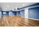 Finished basement with wood-look floors, recessed lighting, and natural light at 5395 S Flanders Way, Centennial, CO 80015