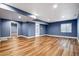 Spacious finished basement featuring wood-look floors, recessed lighting, and bathroom access at 5395 S Flanders Way, Centennial, CO 80015