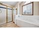 Bathroom with a shower, bathtub and a window for natural light at 5395 S Flanders Way, Centennial, CO 80015