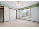 Bright bedroom with white walls, decorative trim, neutral carpet, and a window at 5395 S Flanders Way, Centennial, CO 80015