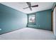 Bright bedroom with neutral carpet, a ceiling fan, and a window at 5395 S Flanders Way, Centennial, CO 80015