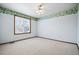 Bright bedroom with white walls, decorative trim, neutral carpet, and a window at 5395 S Flanders Way, Centennial, CO 80015