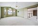 Bedroom showcasing a ceiling fan, multiple windows, and access to the hallway at 5395 S Flanders Way, Centennial, CO 80015