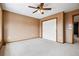 Cozy bedroom with a ceiling fan, neutral carpet, and a closet for storage at 5395 S Flanders Way, Centennial, CO 80015