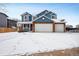 Inviting two-story home with an attached two car garage on a snowy lot at 5395 S Flanders Way, Centennial, CO 80015