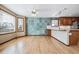 Eat-in kitchen featuring hardwood floors, two windows and a unique tiled accent wall at 5395 S Flanders Way, Centennial, CO 80015