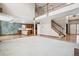 Open-concept living room featuring a fireplace, lofted space, staircase, and adjacent kitchen at 5395 S Flanders Way, Centennial, CO 80015