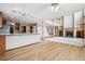 Open-concept living room featuring a fireplace, hardwood floors, and an adjacent kitchen at 5395 S Flanders Way, Centennial, CO 80015