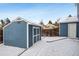 Exterior view of backyard shed with double doors and snow-covered yard at 5395 S Flanders Way, Centennial, CO 80015