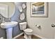 Stylish powder room with pedestal sink, modern fixtures, and decorative wall art enhances the home's appeal at 834 N Bently St, Watkins, CO 80137