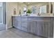 Bathroom features a double sink vanity with gray wood cabinets and neutral countertops at 834 N Bently St, Watkins, CO 80137