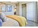 Serene bedroom with closet space, soft yellow decor, and minimalist wall art at 834 N Bently St, Watkins, CO 80137