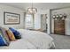 Bright bedroom featuring a large bed with stylish bedding, modern chandelier, and decorative accents at 834 N Bently St, Watkins, CO 80137