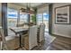 Dining area featuring large windows, modern light fixture, stylish table and chairs, and hardwood floors at 834 N Bently St, Watkins, CO 80137