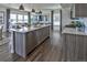 Bright, open kitchen featuring stainless appliances, a spacious island, and an open living area at 834 N Bently St, Watkins, CO 80137