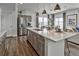 Bright kitchen with stainless appliances, spacious island, and lots of cabinets at 834 N Bently St, Watkins, CO 80137