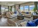 Living room featuring stylish sofas, large windows, hardwood floors, and modern decor at 834 N Bently St, Watkins, CO 80137