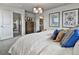 Comfortable main bedroom features plush bedding, elegant decor, and ample natural light for a serene retreat at 834 N Bently St, Watkins, CO 80137