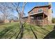 Backyard with mature tree, full lawn, deck and view of neighboring house at 13648 W 66Th Way, Arvada, CO 80004