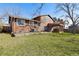 Backyard featuring grass, deck, and a two story house at 13648 W 66Th Way, Arvada, CO 80004