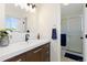 Modern bathroom featuring stylish vanity with sleek fixtures, a well-lit mirror, and a glass-enclosed shower at 13648 W 66Th Way, Arvada, CO 80004