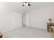 A bedroom with neutral carpet, ceiling fan, closet, and light walls at 13648 W 66Th Way, Arvada, CO 80004