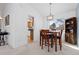 Cozy dining area open to the kitchen, featuring a wooden table and chairs at 13648 W 66Th Way, Arvada, CO 80004
