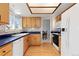 Bright kitchen with a window, cabinets, white appliances, and blue countertops at 13648 W 66Th Way, Arvada, CO 80004