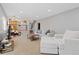 Bright living room with neutral tones, recessed lighting, open layout to kitchen, and comfortable modern furnishings at 13648 W 66Th Way, Arvada, CO 80004